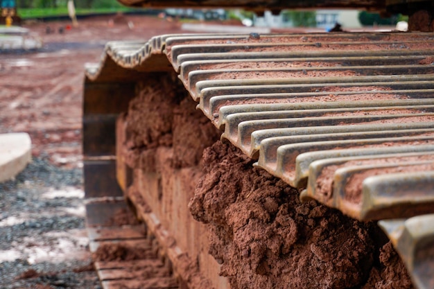 Close up shot of excavator track chain on construction site