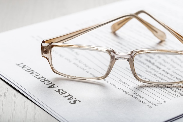 Close up shot of Eyeglasses  on contract document papers business concept