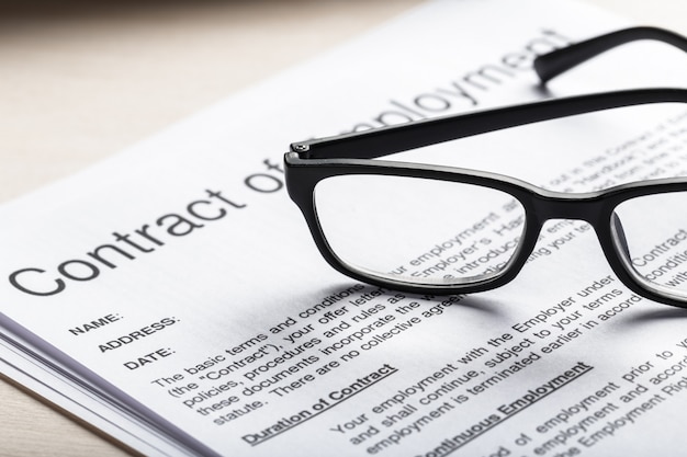 Close up shot of Eyeglasses  on contract document papers 