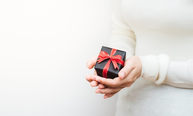 Close up shot of female holding a small gift wrapped