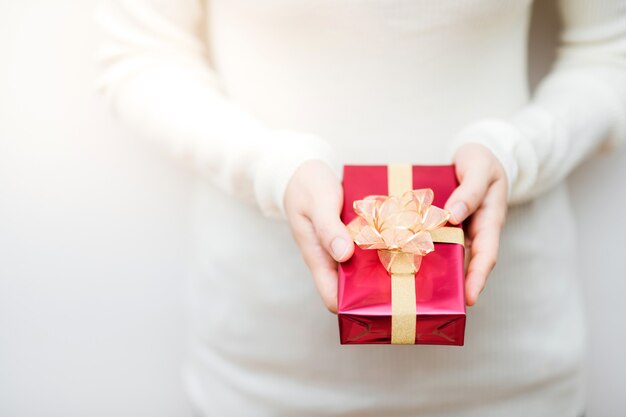 Close up shot of female holding a small gift wrapped