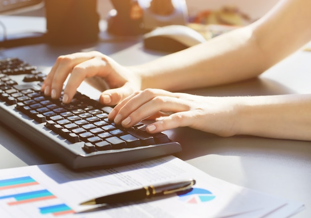 Close-up shot of a female learner typing on the keyboard