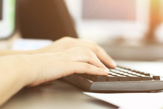 Close-up shot of a female learner typing on the keyboard