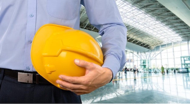 Close-up shot of a foreman holding a hardhat on the construction site