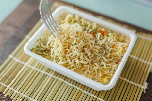 A close up shot of a fork in the hands of someone at home savoring a steaming plate of showing insta