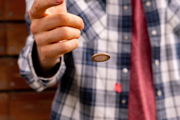 Close up shot of hand toss a coin probable and winning chances concept fiftyfifty s