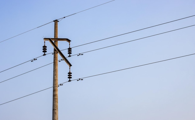 Close up shot of high voltage electricity transmission pole in the urban area with copy space