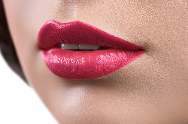 Close up shot of the lips of a woman wearing lipstick or lip glo