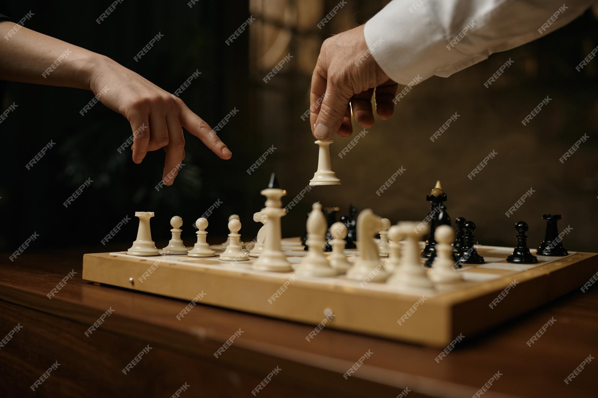 Hand Of A Man Taking A Chess Piece To Make The Next Move In A Chess Game.  Close Up. Spring Day Outside. Stock Photo, Picture and Royalty Free Image.  Image 198493516.