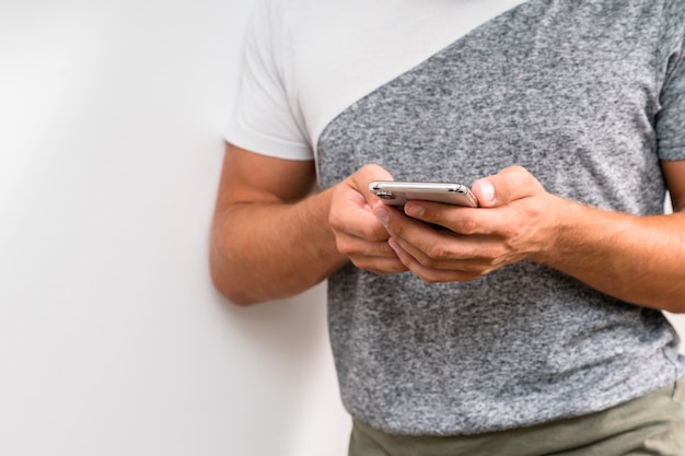 Close up shot of man's hands holding smart cell phone