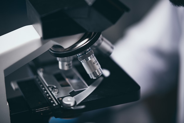 Close-up shot of microscope with metal lens at laboratory.