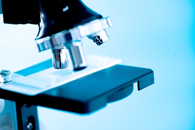 Close-up shot of microscope with metal lens at laboratory.