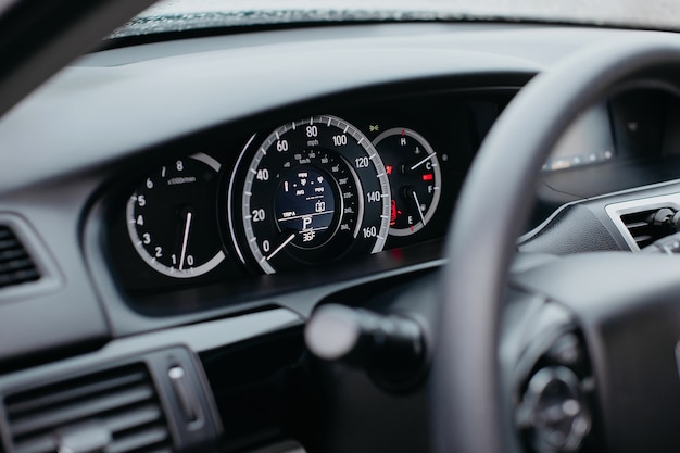 Close up shot of a miles speedometer in a car. Car dashboard. Dashboard details with indication lamps.Car instrument panel. Dashboard with speedometer, tachometer, odometer.