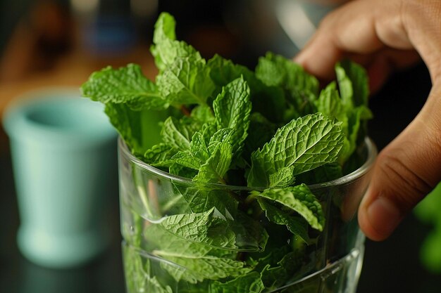 Photo close up shot of mint leaves being muddled in a glass