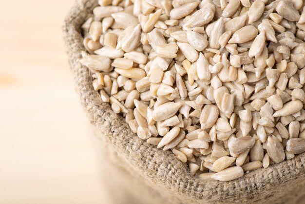 Close up shot of peeled sunflower grain in a linen sack Cooking with sunflower seed concept