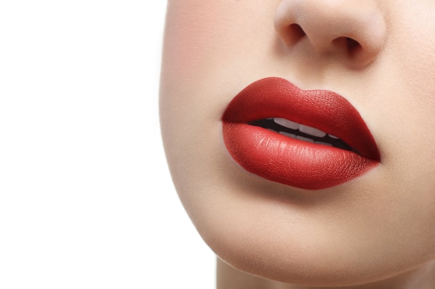 Close up shot of plump sexy female lips covered with lipstick