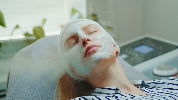 Close-up shot of professional facial skin care treatment with a cosmetic steamer at beauty salon