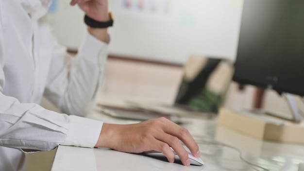 Close up shot of Programmer hand using computer mouse, Computer concept, Computer on programmer desk.