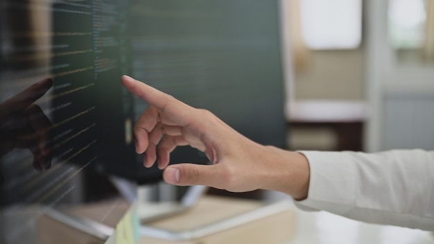 Close up shot of Programmers pointing fingers at the code on a computer screen, Computer programming, Learning programming.