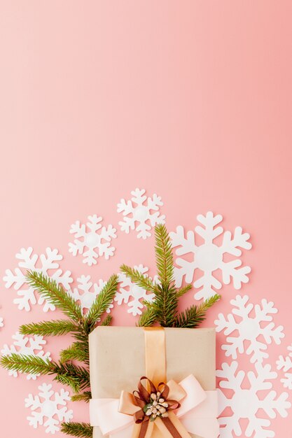 Close up shot of small gift wrapped with ribbon. Christmas background. Minimal concept. Flat lay. Top view