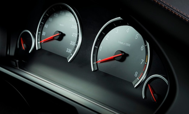 Close up shot of a speedometer and tahometer in a car