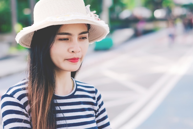 Close up shot of stylish young woman in hat against.