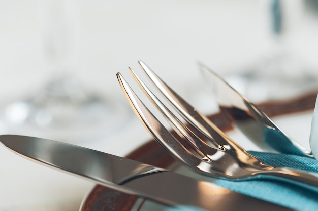 Close up shot of table setting for fine dining with cutlery and glassware