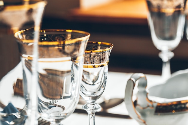 Close up shot of table setting for fine dining with cutlery and glassware