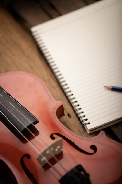 Close-up shot violin orchestra instrumental and notebook