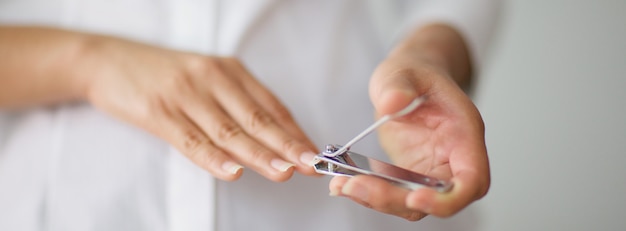 Close up shot of a woman cutting her nails