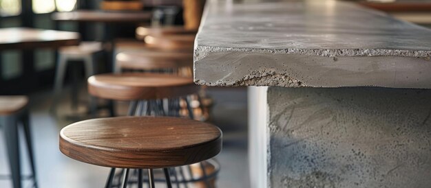 Close up shot of wooden bar stool and concrete table at local cafe with unique architectural design