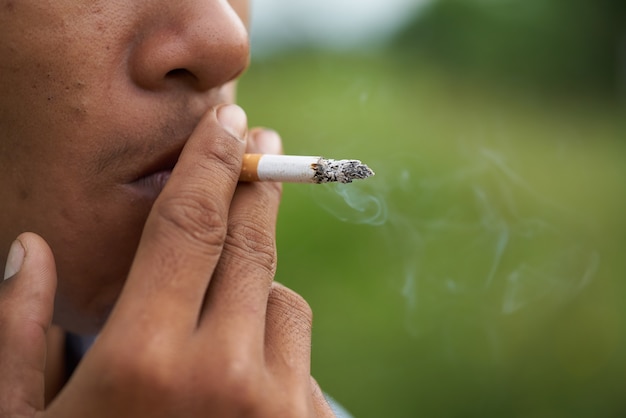 Close-up shot of a worker having a break and smoking 