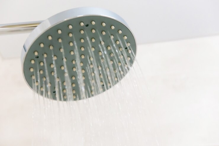 Close up of shower head in the bathroom with running water