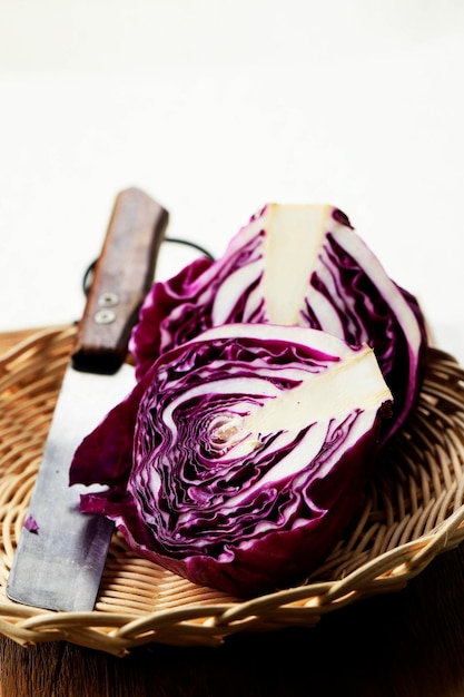 Close up Shredded Sliced and a Whole of Purple Cabbage Vegetable on Top of Wooden Table