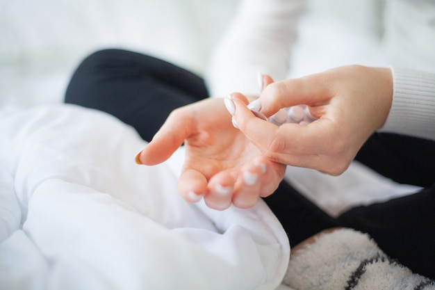 Close up sick woman hold in her hand pill