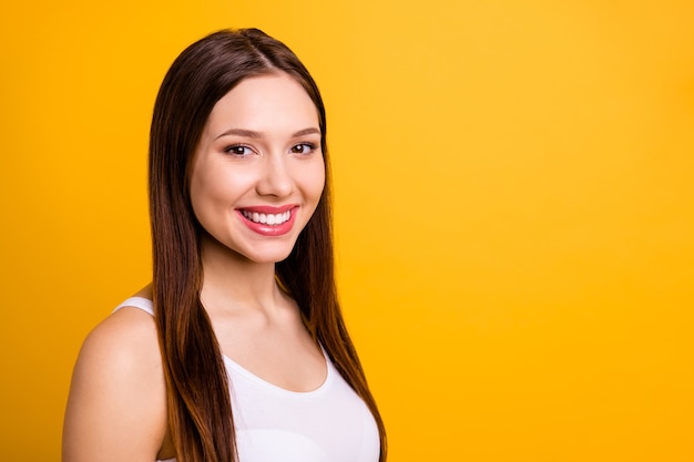 Close up side profile beautiful brunette posing isolated on orange