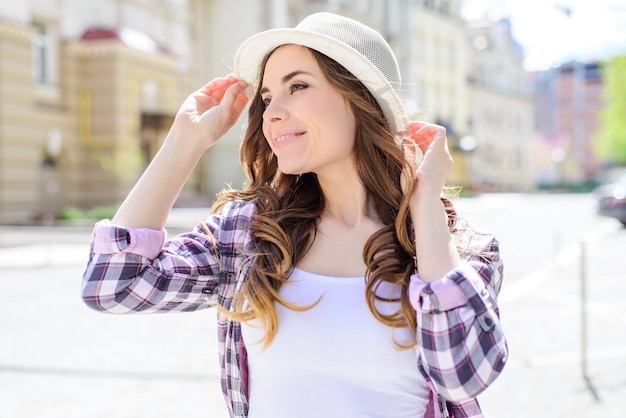 Close up side turned head profile view portrait of sexy carefree beautiful pretty lovely cute lady with wide ideal toothy beaming smile long curly wavy hair in casual checkered shirt white tshirt