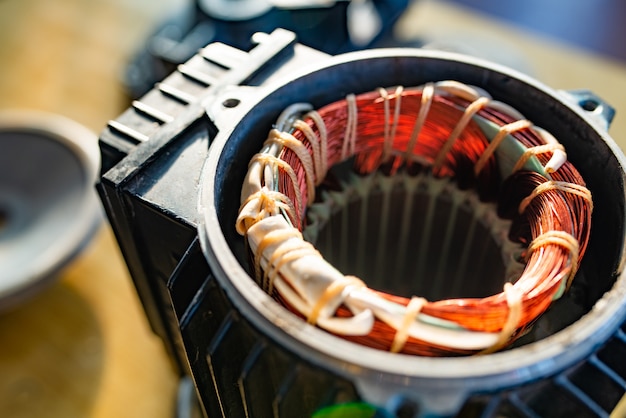 Close-up side view of bundle of  wire sticking out of unidentified plastic equipment in manufacture