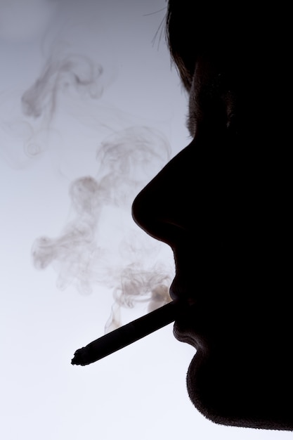 Close up silhouette of smoking man