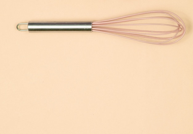 Photo close up on silicone kitchen whisk isolated
