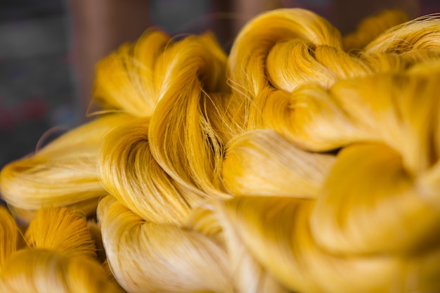 Close up the silk thread lustrous fiber produced by silkworms.