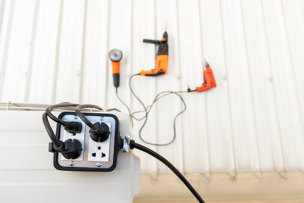 Photo close-up of silver colored trailer plug 4 sockets on the roof for use with hand tools