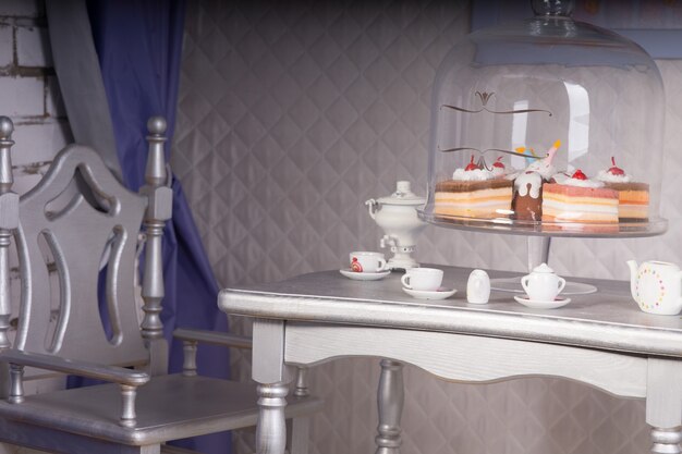 Close Up of Silver Dining Room Table Set for Tea with Variety of Decadent Cakes