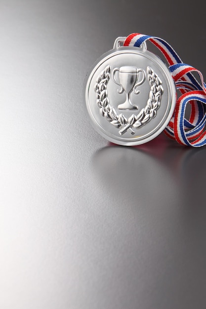 Close-up of silver medal on gray background