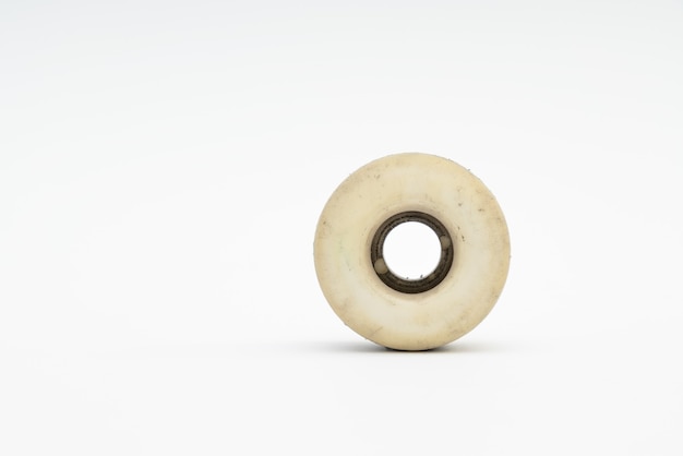 Close up of a skateboard wheel on white background.