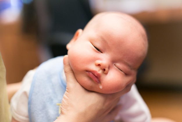 Close-up of sleepy baby boy drooling