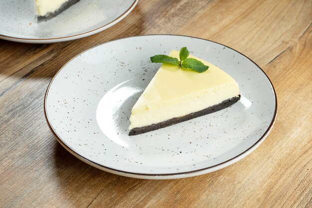 Close up slice of Delicate Airy Lime Cheesecake on white plate. delicious dessert cake after dinner.