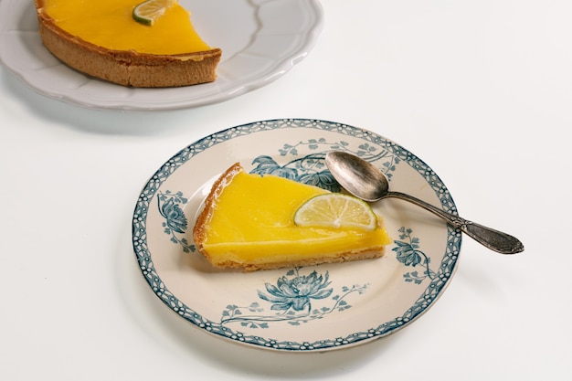 Close up a slice of lemon pie on an elegant plate