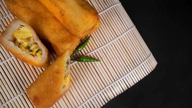 Close up sliced Indonesian Rissoles on a black background