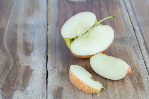 Close up of a sliced red apple on a wooden table background with copy space for use